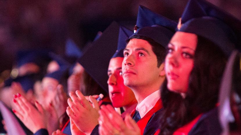 Graduates clap during commencement ceremony