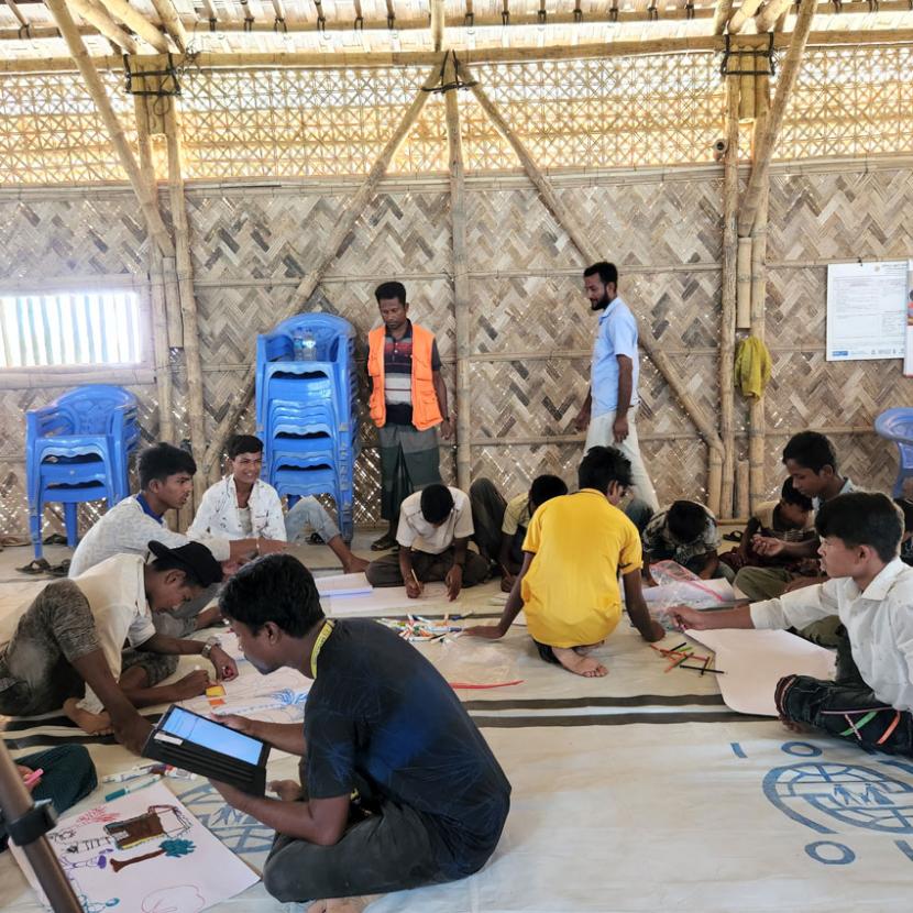 Group of students working together sitting on the floor