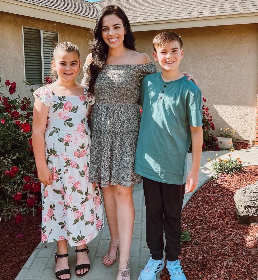 Kelly Kirsch standing with her two children