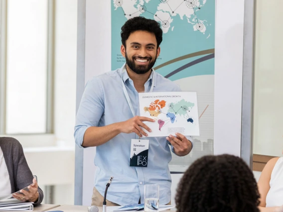 man presenting at a conference