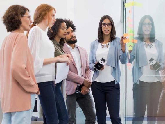 Group of people talking discussing whiteboard