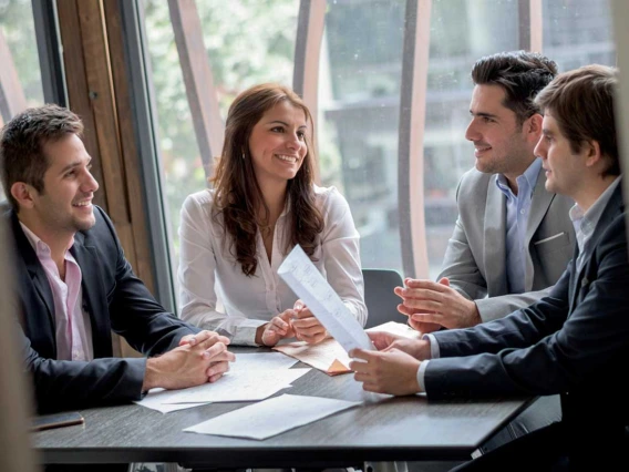 Group of professionals talking around table