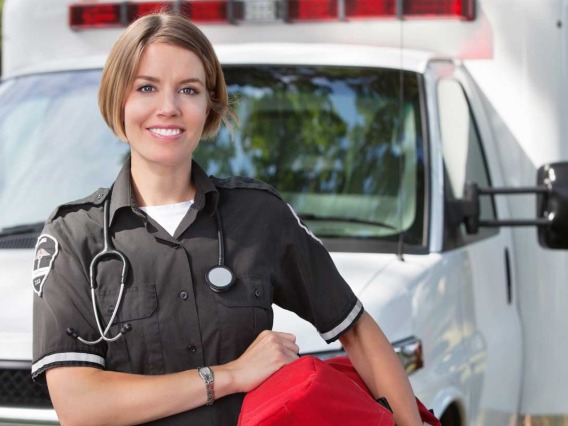 Emergency Medical Technician standing outside ambulance  