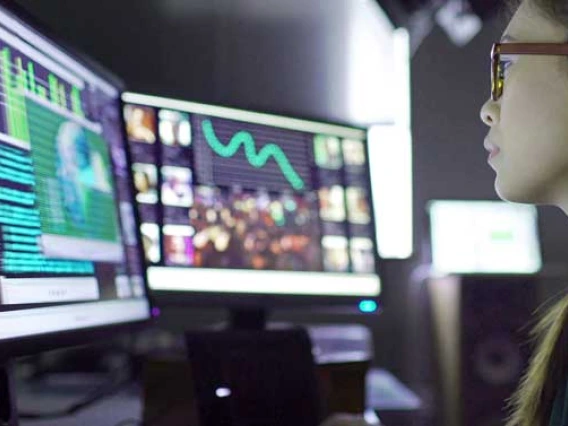 Young woman looking at computer screens