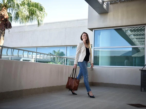 Eller woman walking with briefcase