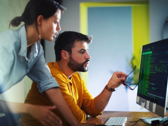 coworkers looking at screen