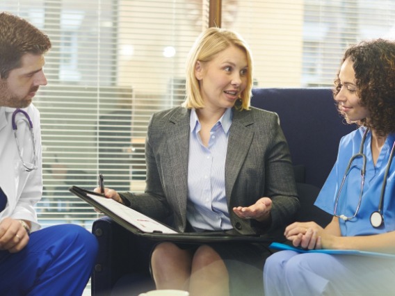 doctor and nurse talk with health professional