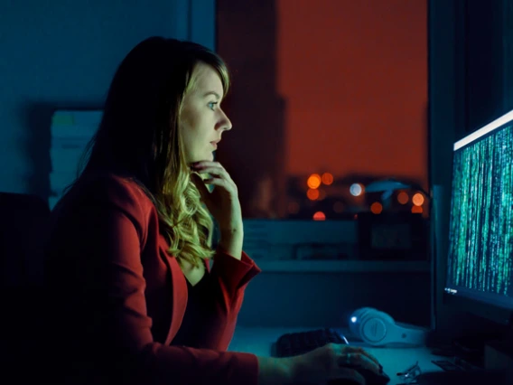 Woman looking at computer with code