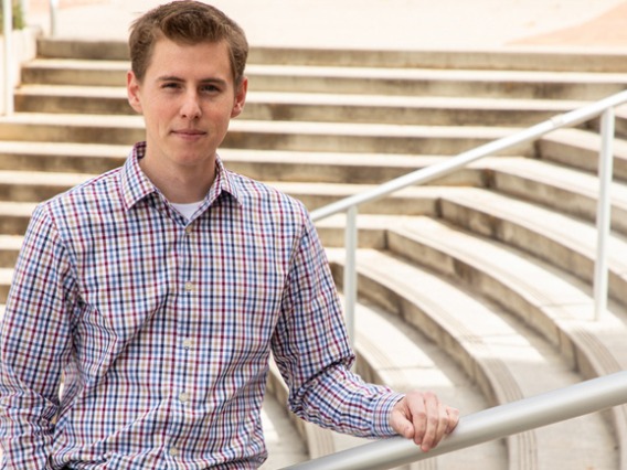 Eller Graduate standing on stairs