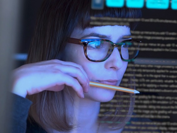 woman studying computer screens