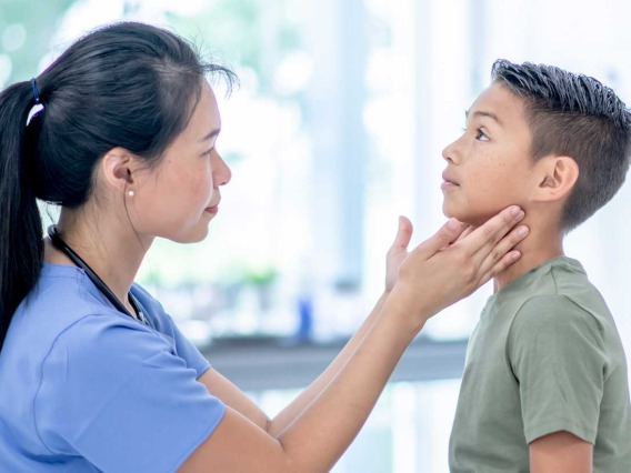 Female nurse examines young boy