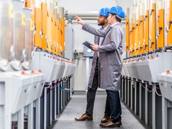 two engineers looking at machinery