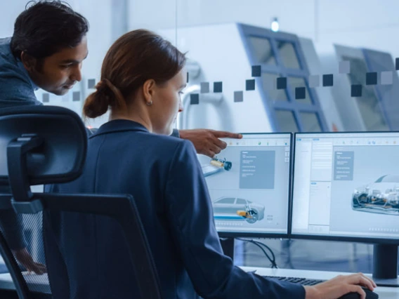 two engineers looking at car design on screen