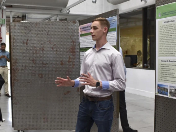 real estate student presenting his thesis poster