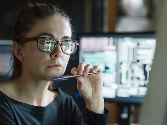 Woman looking at computer with code