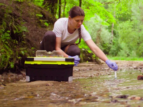 Scientist taking water samples from a river 