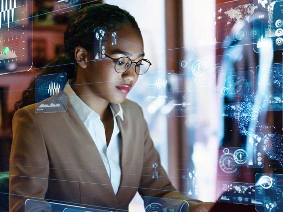 female IT professional surrounded by computer imagery 