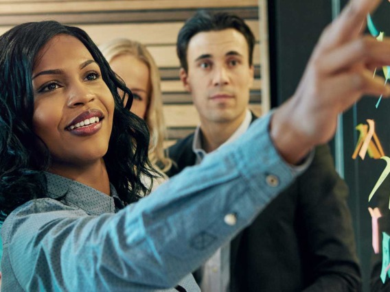 woman pointing to post-it notes on window