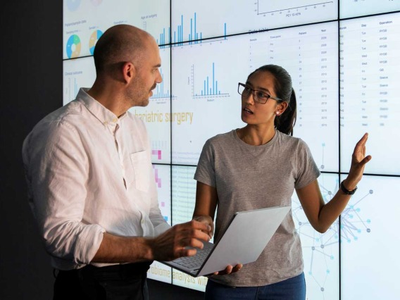 Man and woman discussing Data on a screen