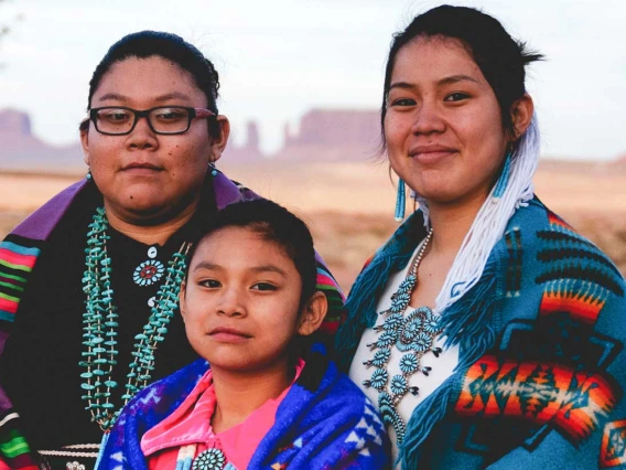 Three Navajo sisters in Monument Valley