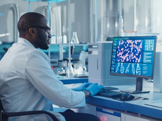 Scientist working on DNA information on a computer 