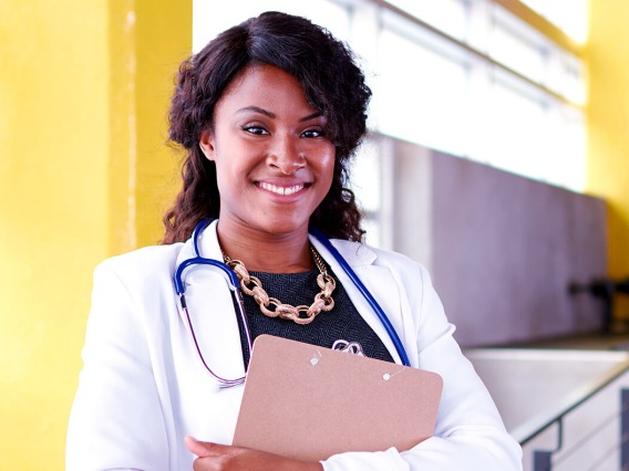 African American nursing student wearing white coat and stethoscope 