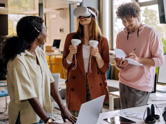 Three young professional designers testing a VR video game 