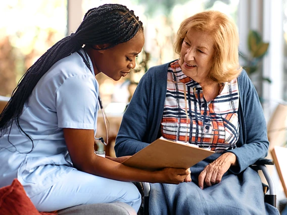 Nursing healthcare professional helping elderly patient