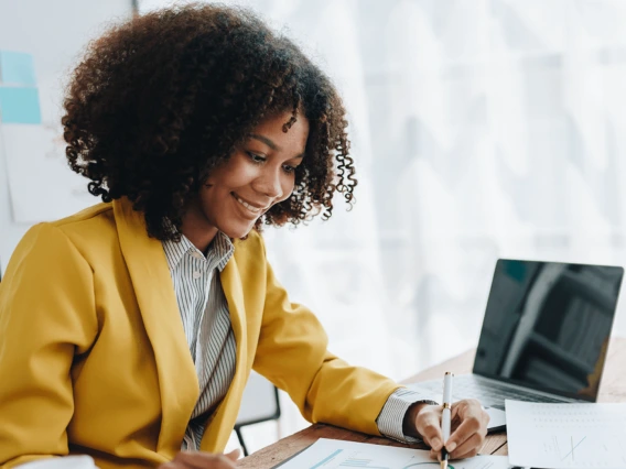 Financial analyst sitting at a desk reviewing a project