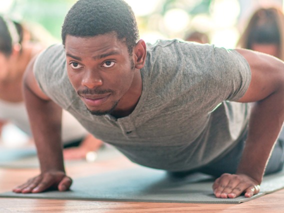 People in an exercise class doing push-ups