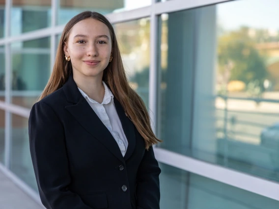 Student in front of a corporate building