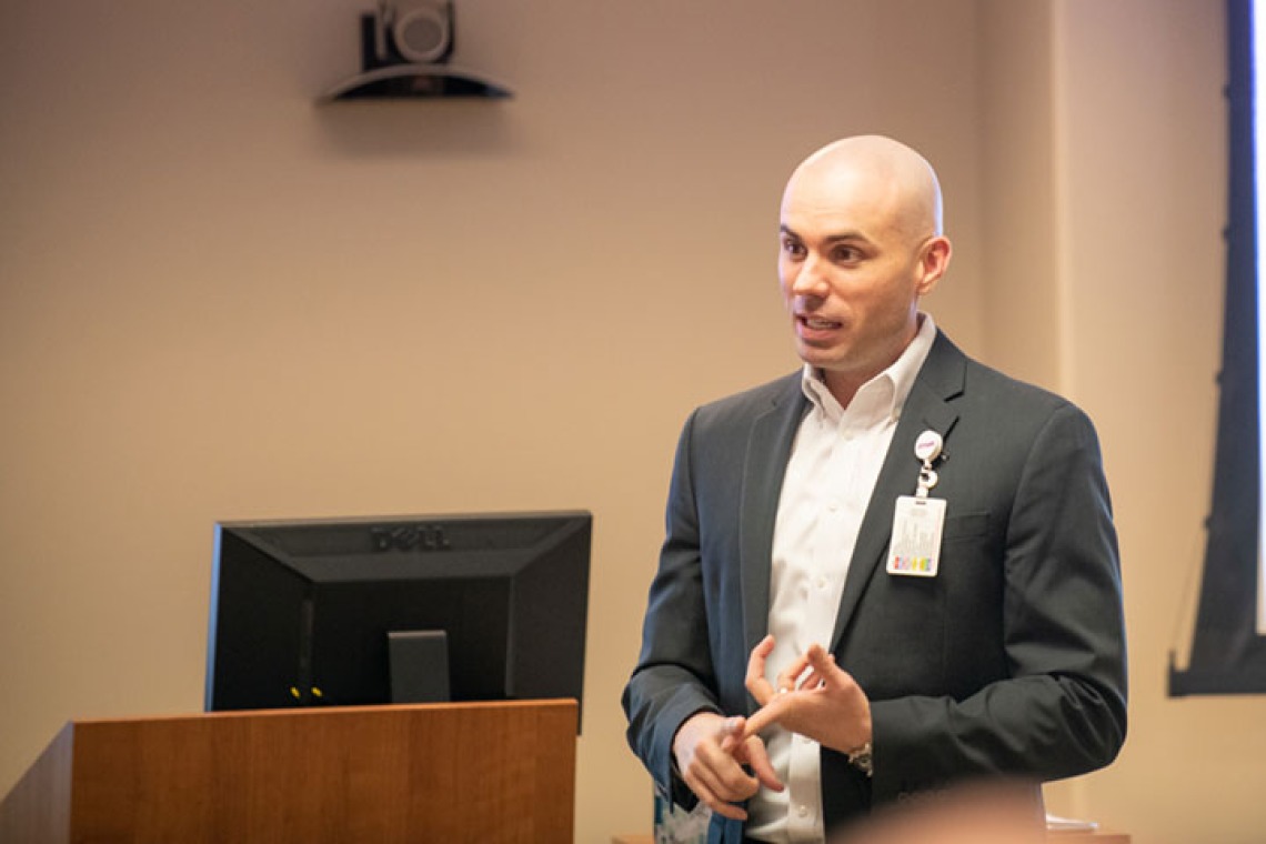 Man giving presentation by podium