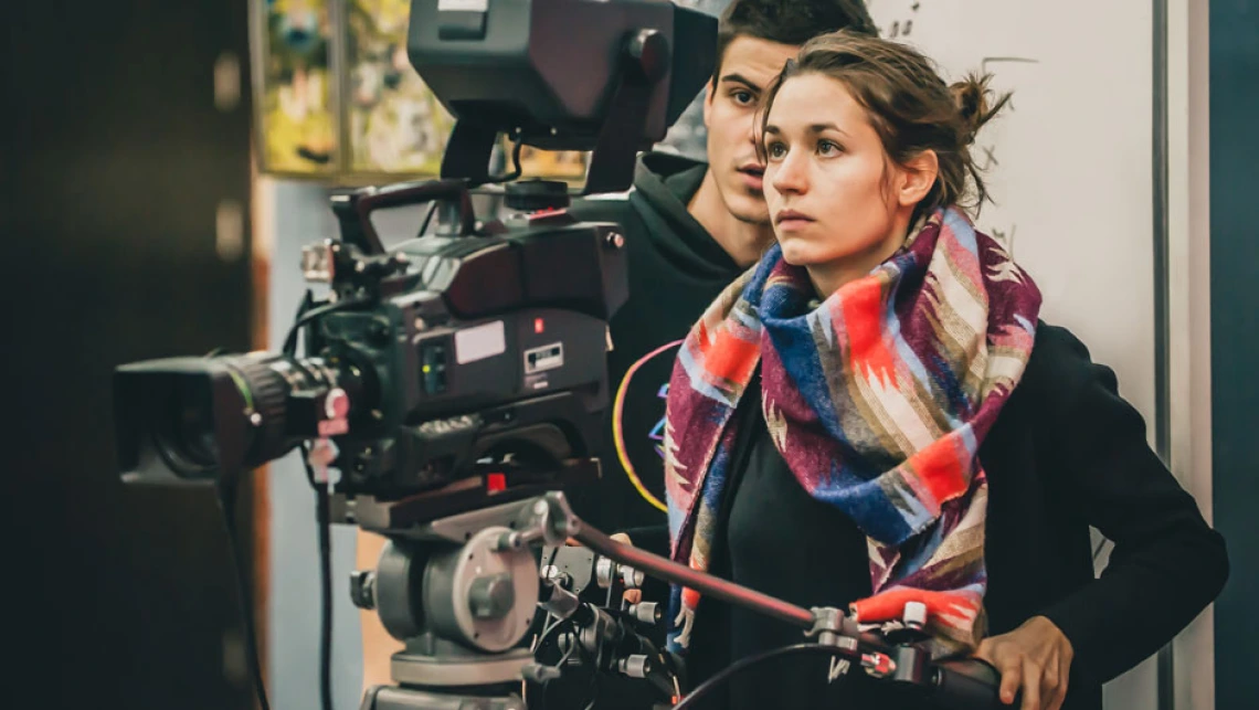 woman operating video camera