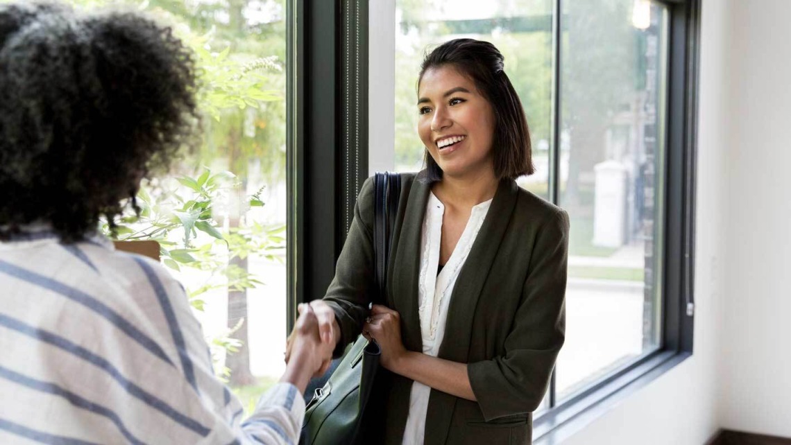 two women shaking hands