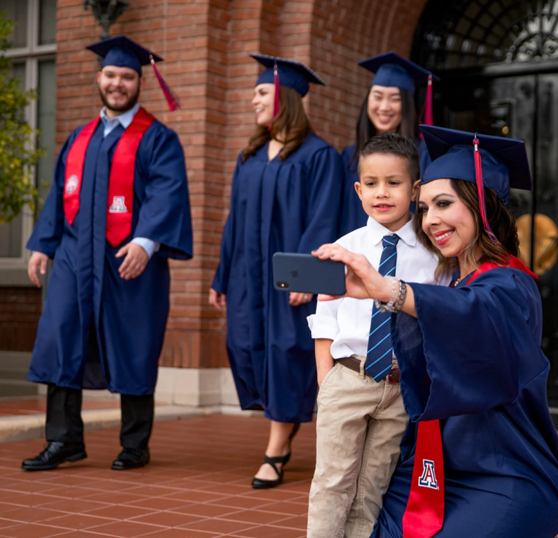 Graduating Mom take selfie with son