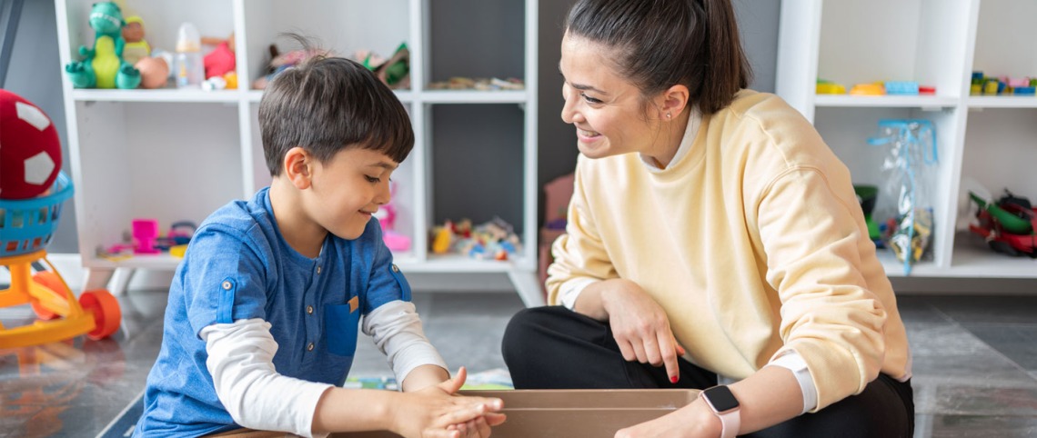 Young child and Behavioral therapist in a playroom 