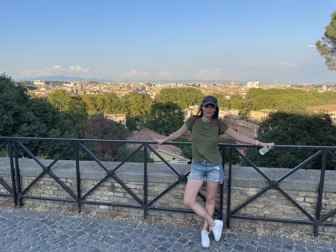 Student, Ashley Lawwill, standing in front of fence in Rome