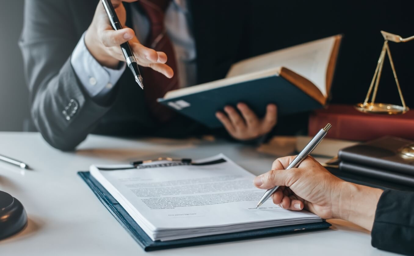 Two Law students discussing a casebook