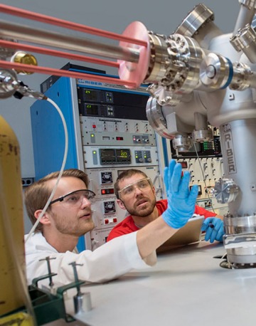 two engineering students working on machines