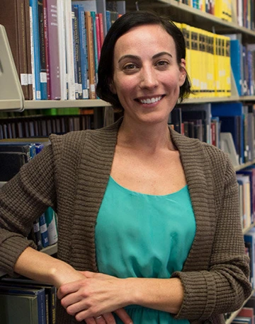 librarian standing alongside bookstacks