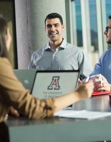 Students talking over laptop