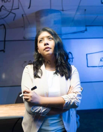 girl looking at text on a glass wall