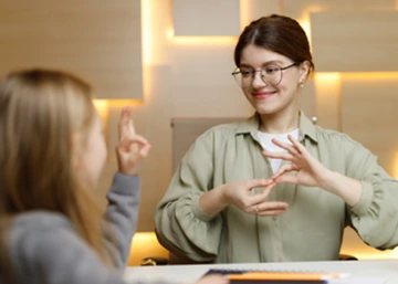 Sign language teacher working with student in classroom