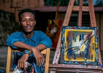 Student sitting with art supplies