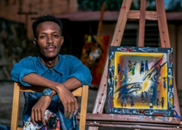 Student sitting with art supplies