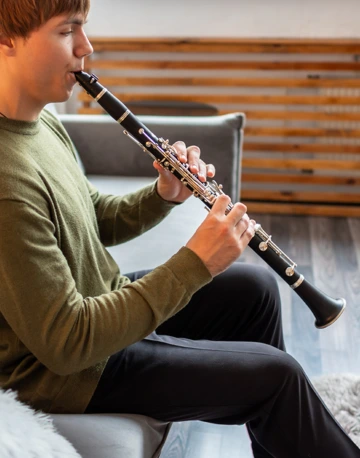 Music student practicing clarinet in their apartment