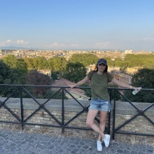 Student, Ashley Lawwill, standing in front of fence in Rome