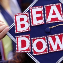 Arizona online student graduating and throwing grad cap with "bear down" written on it