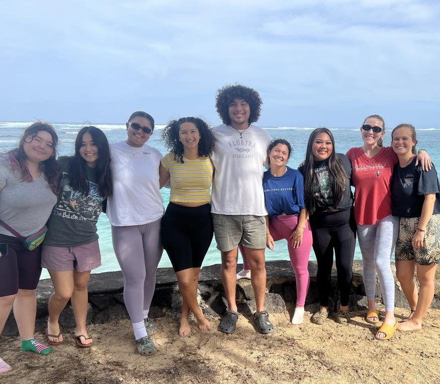 Jhulian and other students standing on the beach in Oahu, Hawaiʻi