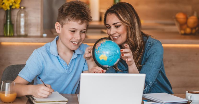 teacher showing a globe to student
